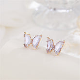 Delicate butterfly-shaped earrings adorned with rose gold plating and sparkling purple crystals.